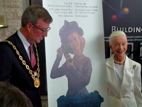 Mayor Jim Watson helps figure skating legend Barbara Ann Scott unveil a collection of her memorabilia that is going on permanent display at City Hall. (Tony Spears/Ottawa Sun)
