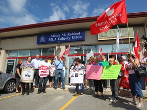 Protesters gather in front of Alberta Premier Alison Redford's constituency office in Calgary, AB August 14, 2012. The group of 50 voiced their opinions on the closure of the Little Bow continuing care centre in the community of Carmangay, about 100 km southeast of Calgary. JIM WELLS/ CALGARY SUN