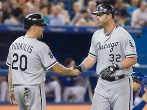 Chicago White Sox Adam Dunn (R) is congratulated by team mate Kevin Youkilis after hitting a three run home run against the Toronto Blue Jays in the seventh inning of their American League MLB baseball game in Toronto August 15, 2012. (REUTERS)