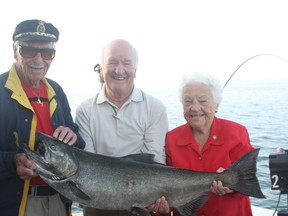 Gordie Tapp, Walter Oster and Hazel McCallion with the catch of the day Thursday, Aug. 16, 2012. (JOE WARMINGTON/Toronto Sun)