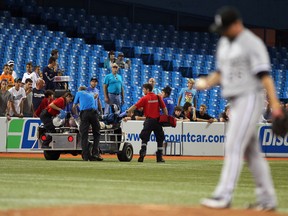 Paramedics stop the game to try and revive a man of an apparent heart attack during MLB action at the Rogers Centre August 16, 2012 in Toronto. (AFP)