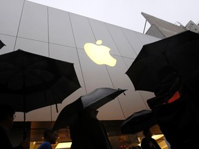 Customers enter the Apple flagship retail store to purchase the new iPad in San Francisco, California in this March 16, 2012 file photograph. (REUTERS/Robert Galbraith/Files)