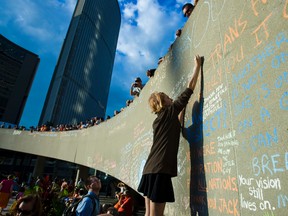 A Jack Layton supporter writes a message on the wall at Nathan Phillips Square Wednesday, Aug. 22, 2012, the first-year anniversary of his death. (ERNEST DOROSZUK/Toronto Sun)