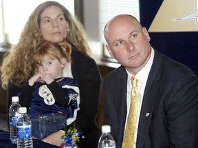 In happier times, Tina LaPolice (left) holds daughter Payton as her husband Paul (right) was introduced as the Blue Bombers head coach during the Feb. 5, 2010 press conference.