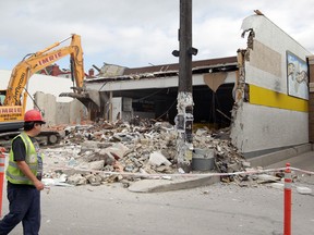 An Imrie Demolition crew works to bring down Movie Village in Osborne Village on Monday, Aug. 27, 2012. (JASON HALSTEAD/Winnipeg Sun)