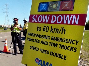 On Thursday, Aug. 30, the EPS and AMA teamed up to educate drivers on the speed limits while passing emergency scenes. CATHERINE GRIWKOWSKY/ Edmonton Sun/ QMI Agency