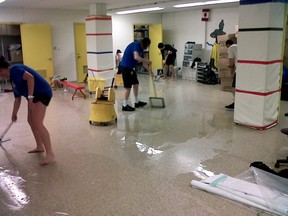 Helping the helpers: Variety Village volunteers clean up after their flood (STAN BEHAL/Toronto Sun).