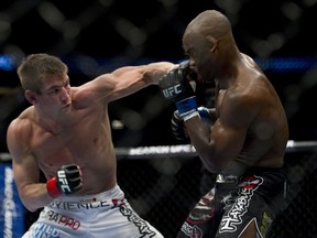 Sam Stout (left) lands a left hand on the chin of Yves Edwards, knocking him out during their fight at UFC 131 at Rogers Arena in Vancouver, B.C., in June 2011. (Richard Lam/QMI Agency)