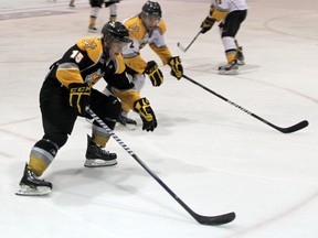 Davis Brown, black, drives to the net against Alex Basso at the Sarnia Sting's annual Black vs. White intrasquad match this week at the RBC Centre. PAUL OWEN / THE OBSERVER / QMI AGENCY