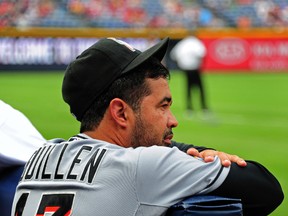 Manager Ozzie Guillen of the Miami Marlins relaxes in the dugout before the game against the Atlanta Braves at Turner Field on August 1, 2012 in Atlanta, Georgia. (SCOTT CUNNINGHAM/Getty Images/AFP)
