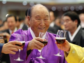 Evangelist Reverend Moon Sun-myung, the founder of the Unification Church, drinks a toast with his family members during his 91st birthday party at Cheongpyeong Heaven and Earth Training Centre in Gapyeong, about 60 km (37 miles) east of Seoul, February 8, 2011. (REUTERS/Jo Yong-Hak)