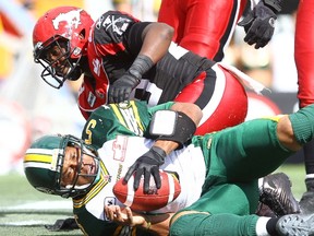 Eskimos quarterback Kerry Joseph is sacked by Stampeders’ Jamar Wall during first-half action Monday in Calgary. (Darren Makowichuk, QMI Agency)