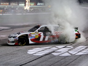 Denny Hamlin performs a burnout in celebration of winning the AdvoCare 500 at Atlanta Motor Speedway on Sunday night. He enters the Chase as the top seed. (GETTY IMAGES)