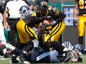 Tiger-Cats kick returner Chris Williams breaks and Argonaut tackle at Ivor Wynne Stadium in Hamilton, Ont., Sept. 3, 2012. (CRAIG ROBERTSON/QMI Agency)