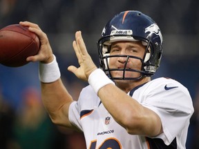 Broncos quarterback Peyton Manning warms up prior to a pre-season match against the Bears at Soldier Field in Chicago, Ill., Aug. 9, 2012. (JOHN GRESS/Reuters)