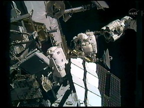 Japanese astronaut Akihiko Hoshide (R) and fellow astronaut Sunita Williams(L) are seen during a scheduled spacewalk outside the International Space Station(ISS) on Sept. 5, 2012. (NASA TV/HO)