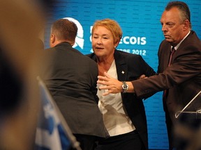 PQ leader Pauline Marois is rushed off the stage after a shooting outside Metropolis nightclub in Montreal, September 4, 2012. (BEN PELOSSE/QMI Agency)