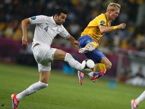 France's Adil Rami is challenged by Sweden's Christian Wilhelmsson during their Group D Euro 2012 soccer match at the Olympic stadium in Kiev June 19, 2012. (REUTERS)