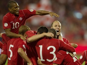 Canadian players celebrate Dwayne De Rosario's winning goal in the second half of their FIFA 2014 World Cup Qualifier against Panama at BMO field in Toronto, Ontario, September 7, 2012.  (GEOFF ROBINS/AFP)