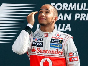 Lewis Hamilton reacts as he celebrates on the podium after winning the Italian Grand Prix in Monza, Italy on Sunday, Sept. 9, 2012. (Giampiero Sposito/Reuters)