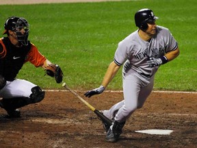 New York Yankees batter Mark Teixeira (R) hits into a game-ending double play against the Baltimore Orioles in the ninth inning of their MLB baseball game in Baltimore September 8, 2012. REUTERS/Gary Cameron