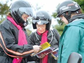 PLOTTING A COURSE
MIKE BEITZ The Beacon Herald
Susan Salmons, Barbie Van Allen and Lyla Van Poele consult a map before heading out on their motorcycles for the Wicked Ride in this file photo in 2012.