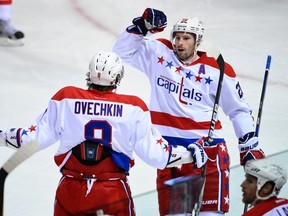 Troy Brouwer, seen here celebrating an Alex Ovechkin goal, signed a new contract with the Capitals on Wednesday, Sept. 12, 2012. (Martin Chevalier/QMI Agency/Files)
