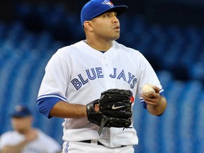 Blue Jays starting pitcher Ricky Romero pauses on the mound against the Mariners at the Rogers Centre in Toronto, Ont., Sept. 12, 2012. (MIKE CASSESE/Reuters)