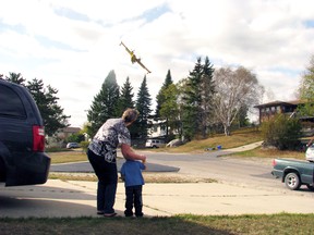 Residents watch a MNR waterbomber climbs into action.
REG CLAYTON/Daily Miner and News