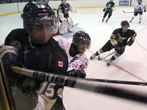 Sarnia Legionnaires forward Derek D'Andrea checks LaSalle Viper Zack Percy in the corner during the first period of the Legionnaires home opener Thursday, Sept. 13, 2012 at Sarnia Arena in Sarnia, Ont. PAUL OWEN/THE OBSERVER/QMI AGENCY