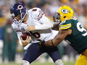 Chicago Bears quarterback Jay Cutler, left, is sacked by Green Bay Packers defensive tackle Jerel Worthy in the second half during their NFL football game in Green Bay, Wisconsin September 13, 2012. (REUTERS/Darren Hauck)