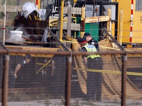 Toronto Police and TTC officials examine the scene along the northbound subway tracks north of Yorkdale Mall where a worker was killed and another seriously injured Sept. 14, 2012. (Dave Abel/Toronto Sun)