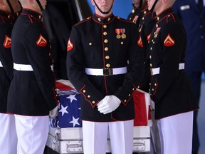 U.S. Marines stand around a casket during the transfer of remains ceremony marking the return to the US of the remains of the four Americans killed in an attack this week in Benghazi, Libya, at the Andrews Air Force Base in Maryland on September 14, 2012. US Ambassador Christopher Stevens died on Tuesday along with three other Americans in the assault on the consular building in Benghazi, on the 11th anniversary of the September 11 attacks. (AFP/Jewel Samad)