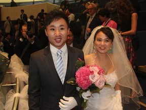 Groom Jea-Yi Kim (L) and bride Sea-Na Moon (R) were just one of 15 happy North Korean refugee couples wed in City Hall Saturday (MARYAM SHAH/Toronto Sun).