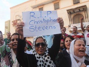 A demonstrator holds placard during a rally to condemn the killers of the U.S. Ambassador to Libya and the attack on the U.S. consulate, in Benghazi September 12, 2012.   REUTERS/Esam Al-Fetori