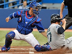 Blue Jays catcher J.P. Arencibia tags out Mariners baserunner John Jaso at home plate on a throw by left fielder Rajai Davis (not shown) at the Rogers Centre in Toronto, Ont., Sept. 11, 2012. (MIKE CASSESE/Reuters)