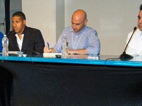 Toronto Blue Jays (L-R) manager John Farrell, coach Luis Rivera, a translator and general manager Alex Anthopoulos listen to  shortstop Yunel Escobar (C) speak during a news conference where the club announced Escobar would be suspended for three games, in New York September 18, 2012. REUTERS/Ray Stubblebine