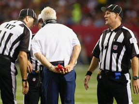 Denver Broncos head coach John Fox holds his challenge flag as he talks to referees during play against the Atlanta Falcons in the first half of their NFL football game in Atlanta, Georgia September 17, 2012.  (REUTERS)