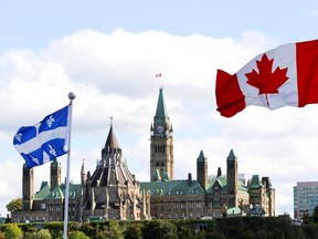 Canadian Flag and Quebec Flag are seen over looking the Ottawa River from the Civilization Museum behind Parliament Hill in Gatineau Sept 19, 2012. (QMI Agency/ANDRE FORGET)