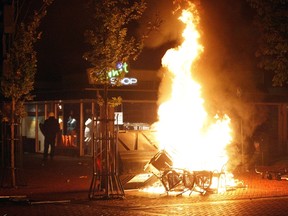 Chairs burn in the northern Dutch town of Haren late on September 21, 2012 as riot police went into action to contain thousands of party-goers who turned up after a teenager's birthday invite on Facebook went viral. (AFP PHOTO/ANP/ CATRINUS VAN DER VEEN netherlands out)