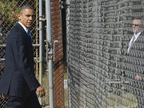 On the campaign trail: US President Barack Obama walks off a baseball field serving as a landing zone for Marine One upon arrival for a campaign rally at G. Richard Pfitzner Stadium in Woodbridge (AFP PHOTO / Saul LOEB).