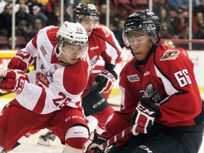 New Soo Greyhounds Sergey Tolchinsky (28) and Windsor Spitfire Josh Ho-Sang(66) collide in the first period. (Rachele Labrecque/Sault Star)