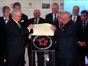 Members of Team Canada 1972 NHL hockey team watch Bobby Clarke (L) and Dennis Hull ( R) unveil their star during Canada's Walk of Fame induction ceremonies in Toronto September 22, 2012. (Reuters/MIKE CASSESE)