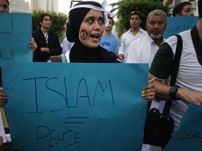 Libyan protesters hold slogans during a demonstration against armed militia in Tripoli on Sept. 21, 2012 to demand the withdrawal of powers conferred on them. (AFP PHOTO/GIANLUIGI GUERCIA)