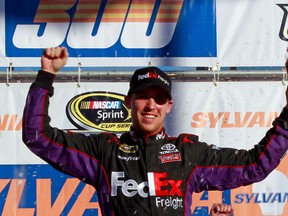 Denny Hamlin celebrates after winning the NASCAR Sprint Cup Series Sylvania 300 at New Hampshire Motor Speedway on Sunday. (Geoff Burke/Getty Images)