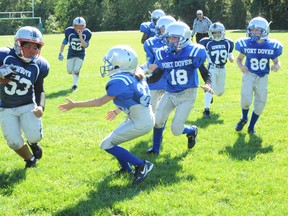 Ashley Courtney of the Port Dover Steelheads atoms prepares to lay the hurt on Dante Arruda-Kerr, running back for the Halton Cowboys in this file photo. (MONTE SONNENBERG Simcoe Reformer)