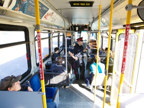 Cst. Jay Robinson gives safety tips to commuters aboard a bus at the Coliseum Transit centre in Edmonton, Alberta on Wednesday, September26, 2012.  Officers were out as part of a week-long initiative by the EPS Community Action Team to educate students and young adults about personal safety and crime prevention. AMBER BRACKEN/EDMONTON SUN/QMI AGENCY