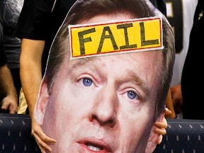 A spectator holds up a cutout of NFL Commissioner Roger Goodell during a game in New Orleans on Sept. 9, 2012. Goodell wrote a letter to fans on Friday addressing the referee fiasco. (Jonathan Bachman/Reuters/Files)