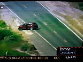 Minutes after getting out of this car, a man being pursued by police shot himself in the head in a field as he was being filmed by Fox News. (Screengrab)