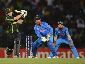 Australia's Shane Watson hits a six watched by India's Mahendra Singh Dhoni and Virat Kohli (right) during the ICC World Twenty20 Super 8 cricket match at the R Premadasa Stadium in Colombo on Friday. (REUTERS)